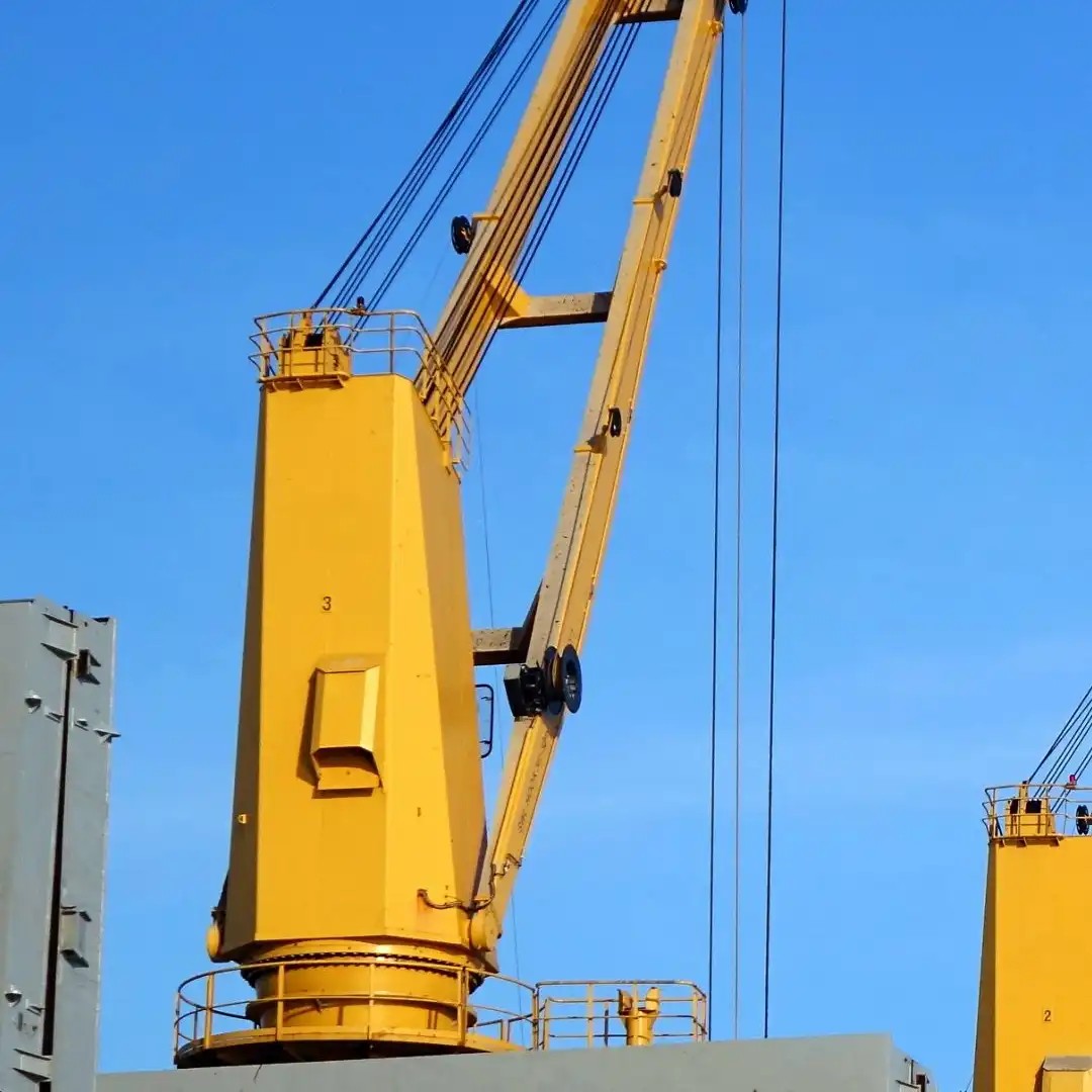 A heavy-lift crane positioning an oversized cargo unit onto a ship's deck